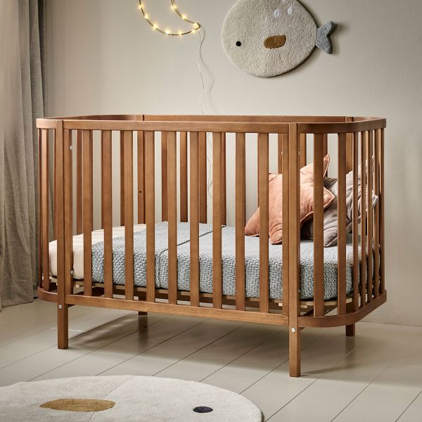 Cot bed made from wood in walnut cocoon from Petite Amélie