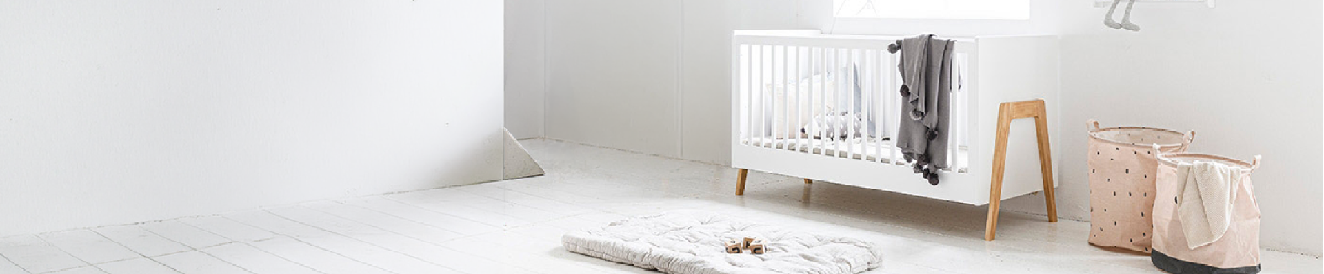 Nursery with white cot and play mat